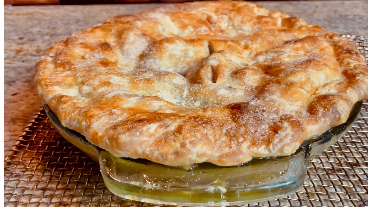 Slice of pie with a scoop of ice cream and a cup of coffee